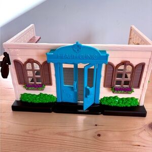 Lil woodzeez Health Clinic with Blue Door and Brown Shutters